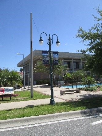 Photo of a decorative streetlight pole with banners hung on the sides.