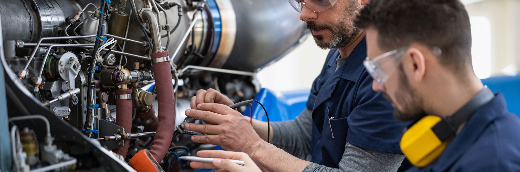 men working on jet engine