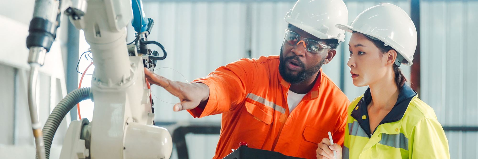 people working on robotic arm